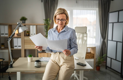 mature woman reading contract | hoa documents